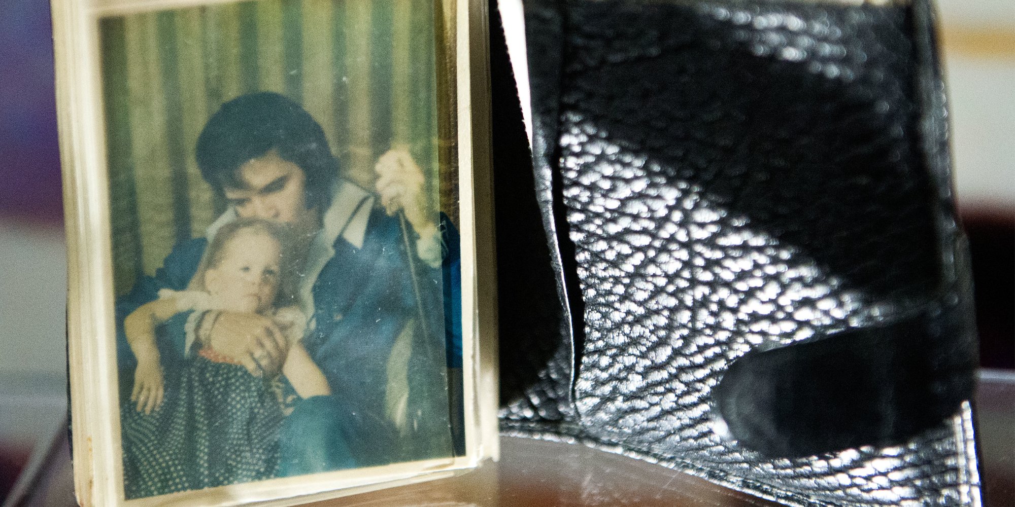 Lisa Marie Presley and Elvis Presley's photograph in a wallet on display at Graceland.
