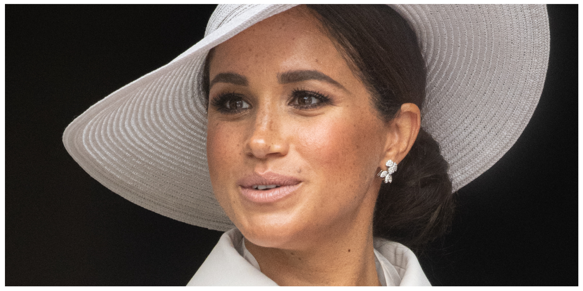 Meghan Markle wears a white hat and suit to a royal event in June 2022.