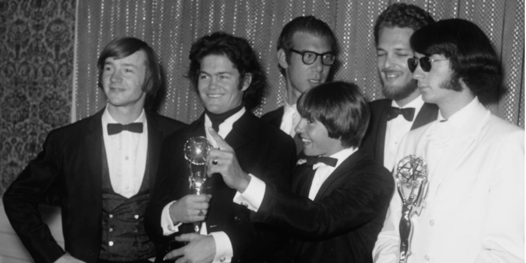 The Monkees cast includes Davy Jones, Mike Nesmith, Mickey Dolenz, and Peter Tork with producers Bob Rafelson and Bert Schneider at the Emmy Awards.