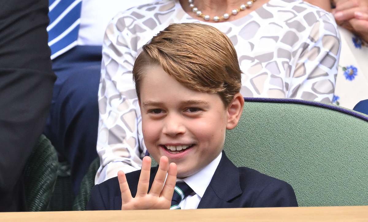 Prince George smiling and waving