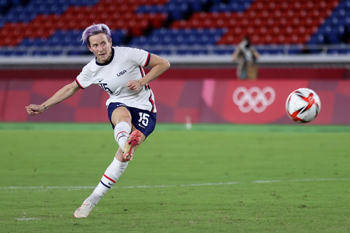 Megan Rapinoe kicking the soccer ball.