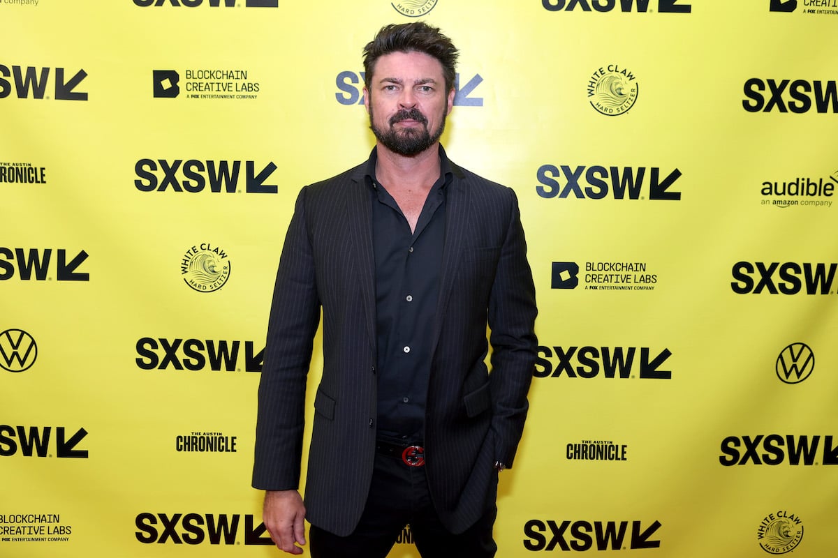 'The Boys' cast member Karl Urban standing in front of a SXSW backdrop