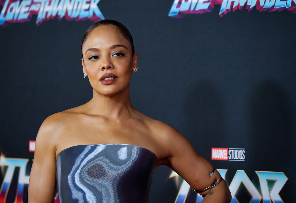 Tessa Thompson at the 'Thor: Love and Thunder' LA premiere posing in a metallic strapless dress