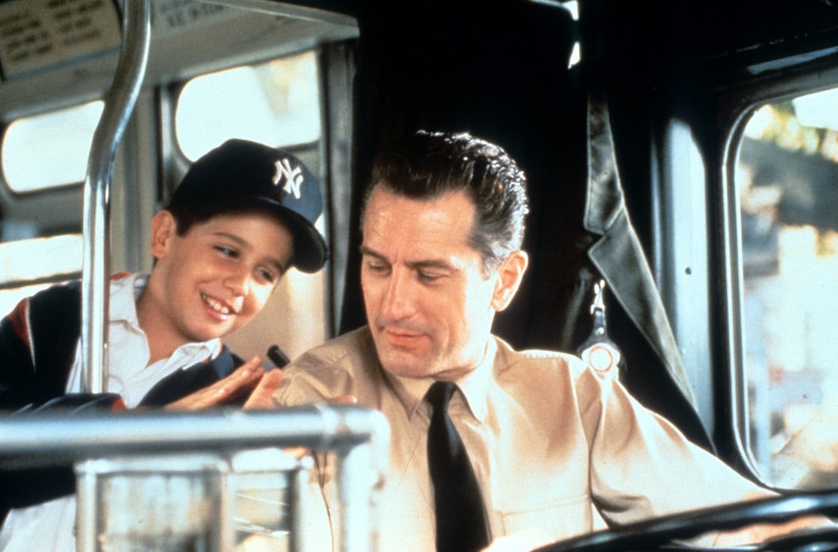 Robert De Niro driving a bus while talking with a young boy in a scene from the film 'A Bronx Tale', 1993.