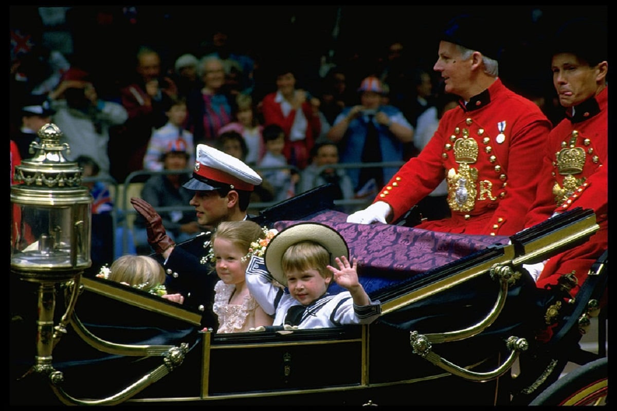 A young Prince William waving as he rides in royal carriage to the wedding of Prince Andrew and Sarah Ferguson