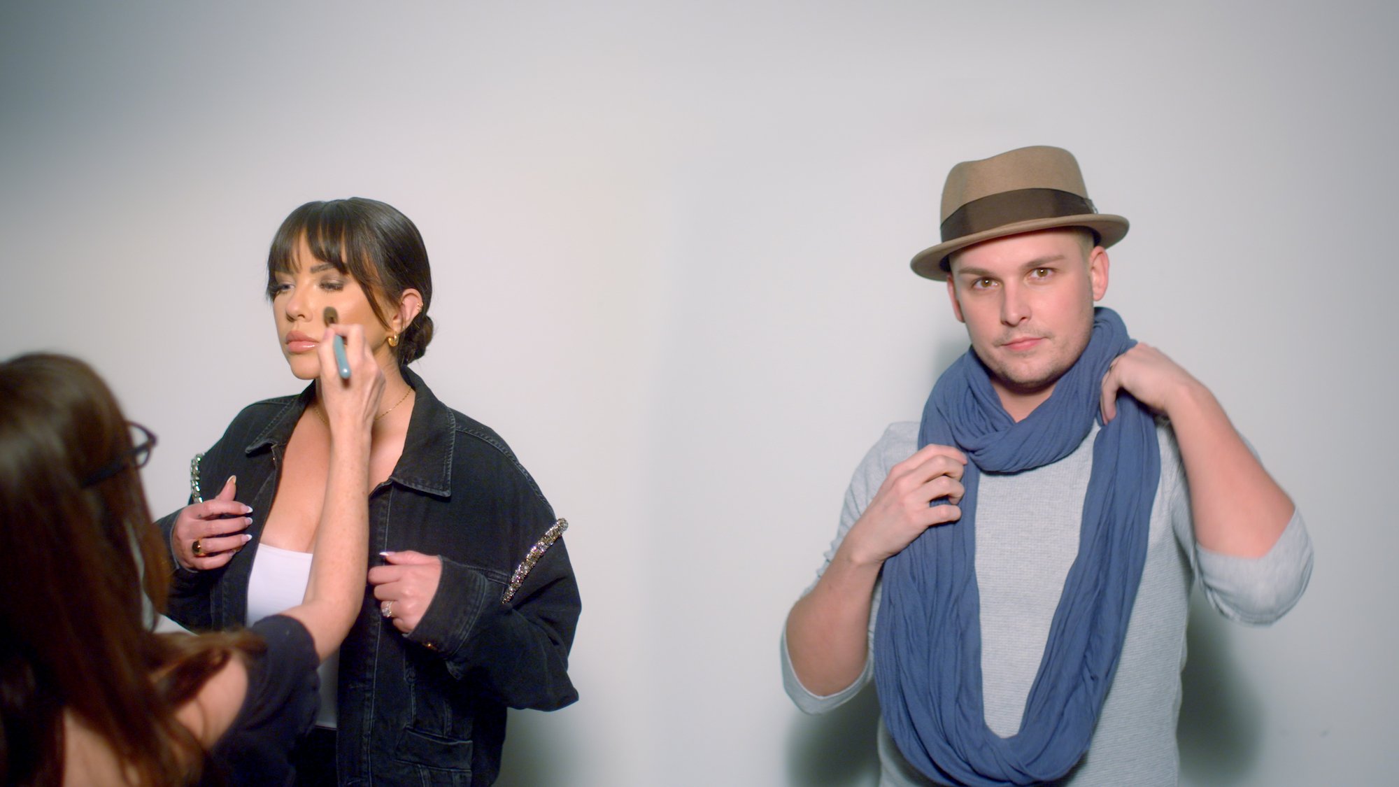 Alexis Neiers and Nick Prugo stand in front of a gray wall in a production still from the Netflix documentary 'The Real Bling Ring: Hollywood Heist.'