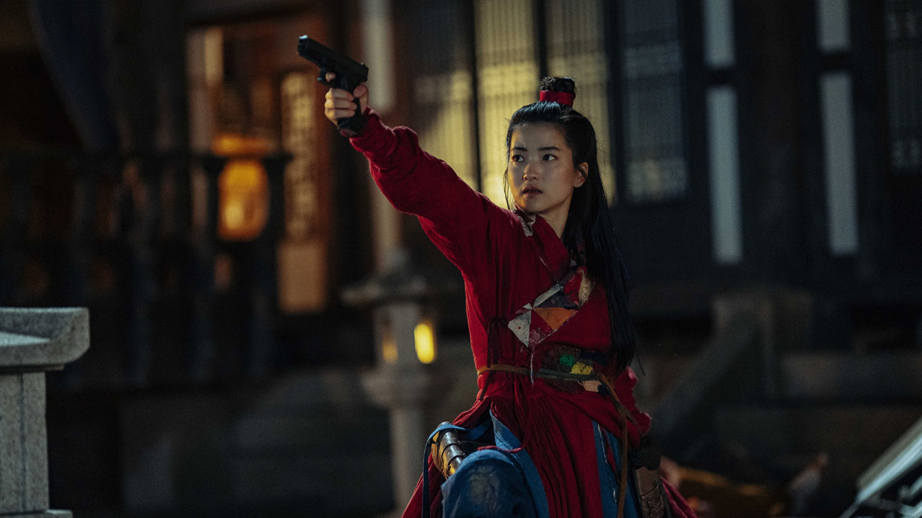 A still from 'Alienoid' by Choi Dong-hoon of Kim Tae-ri as Lee Ahn holding up a pistol. 