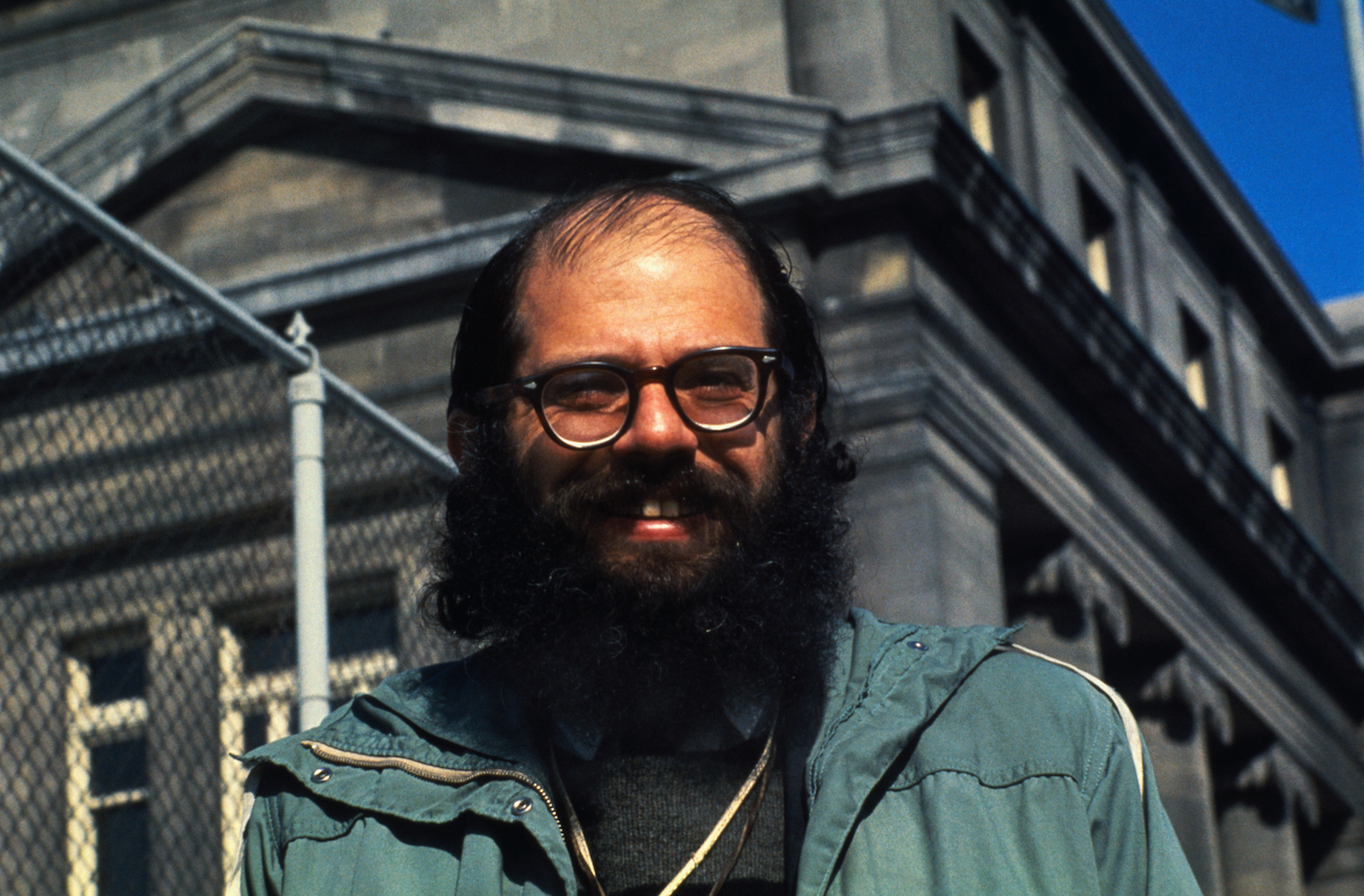 Allen Ginsberg in a green jacket.