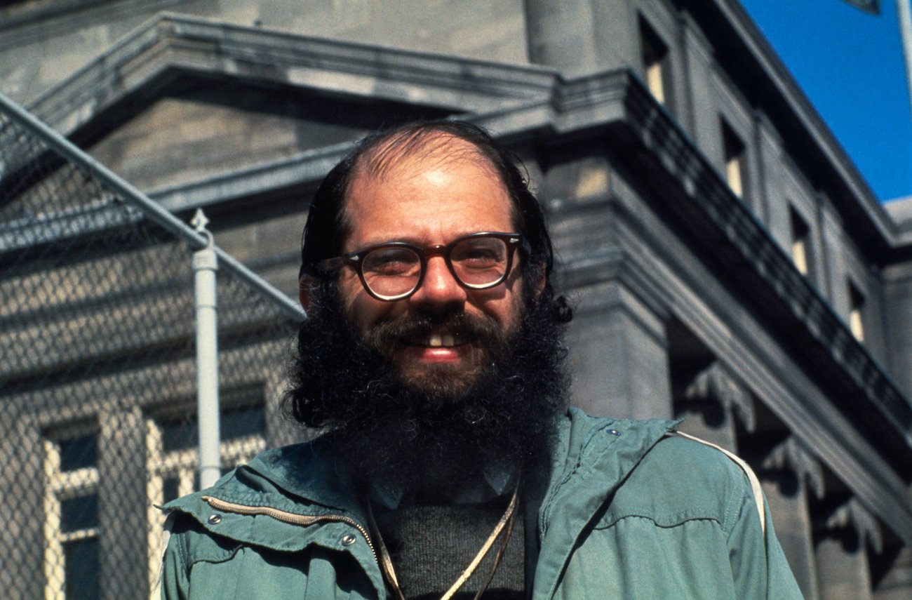 Allen Ginsberg in a green jacket.