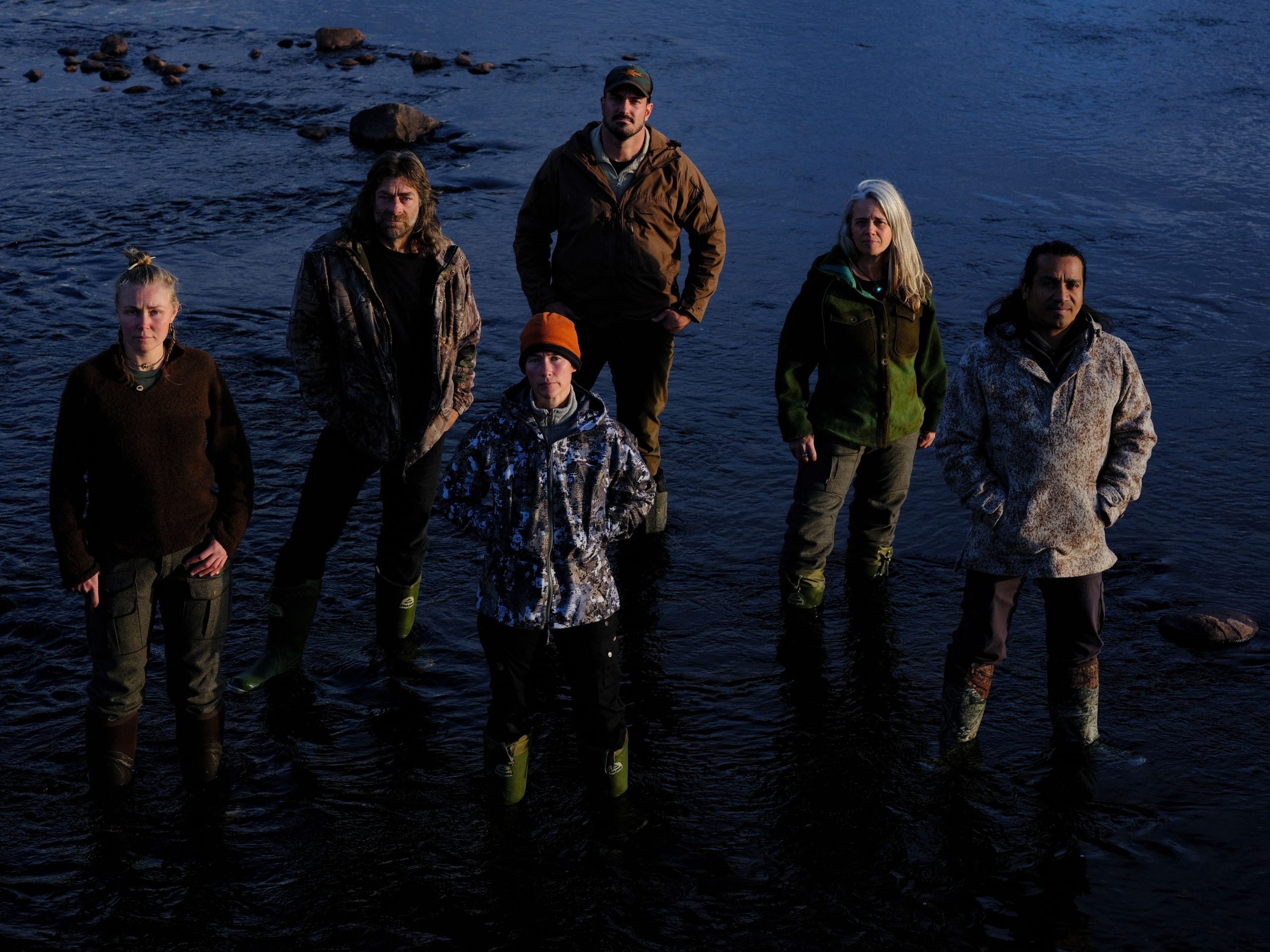 Group shot of the 'Alone: Frozen' cast standing in front of water