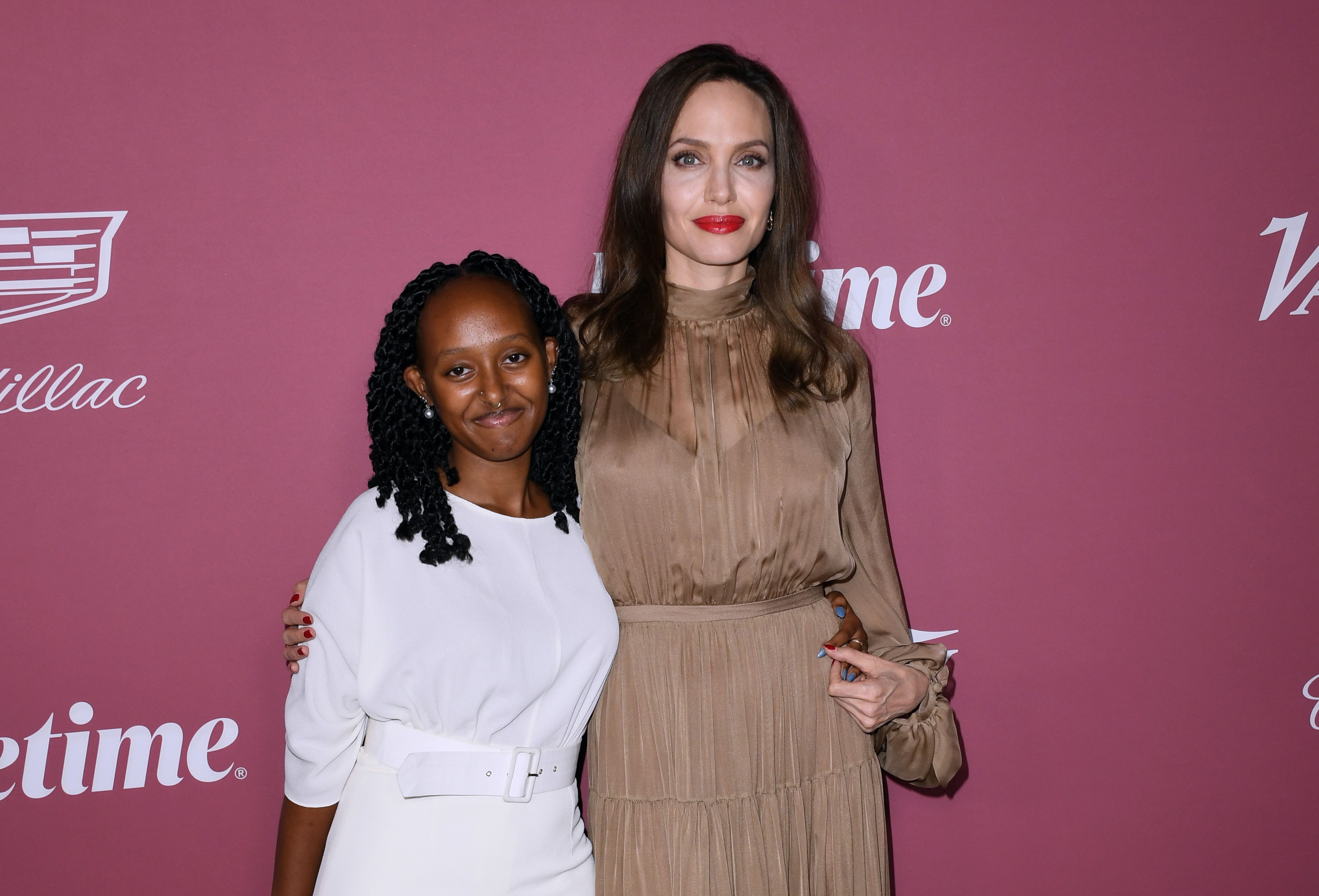 Angelina Jolie and her daugher, Zahara Jolie-Pitt, smile on the carpet at Variety's Power Of Women