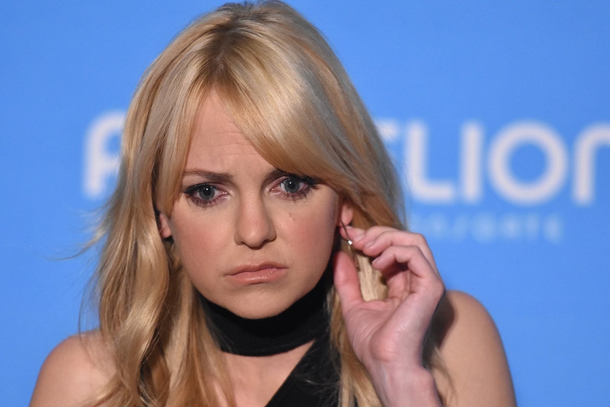 Anna Faris holding her earring.