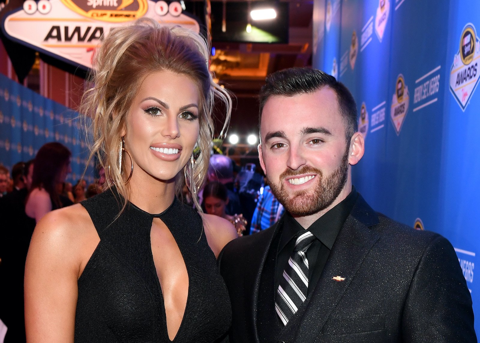 Whitney Dillon and husband Austin Dillon pose for a photo during a NASCAR red carpet event 
