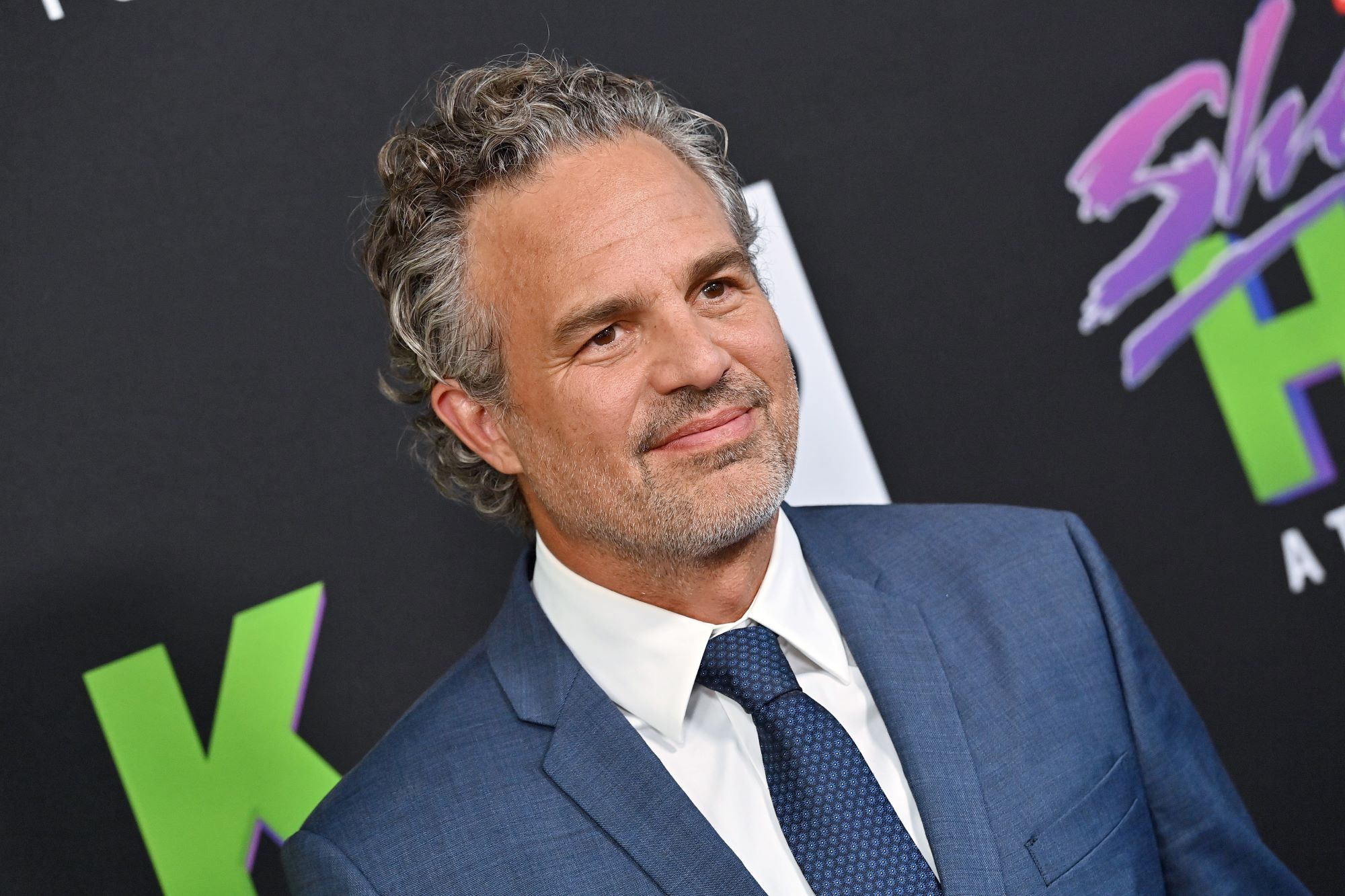 Mark Ruffalo, who stars as Bruce Banner/Hulk in the 'Avengers' movies, wears a blue suit over a white button-up shirt and blue tie.
