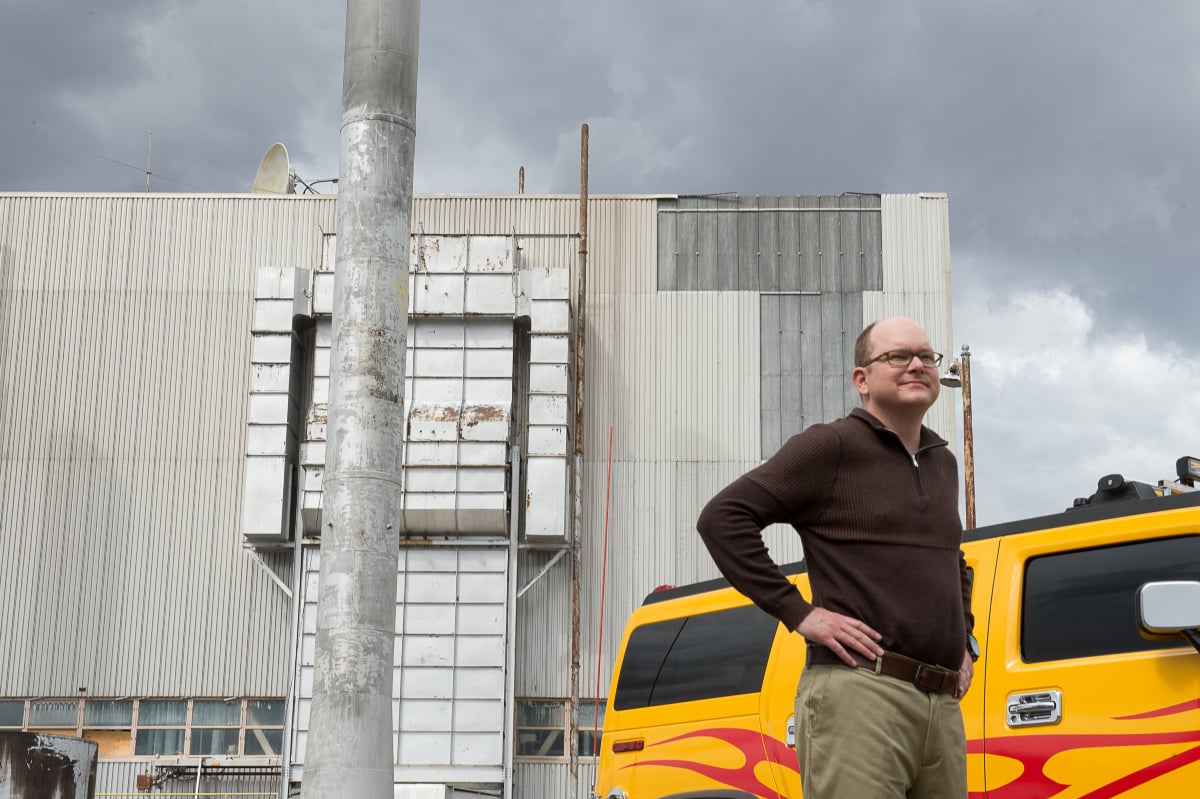 Mark Proksch as Pryce in Better Call Saul Season 2 Episode 1. Pryce stands outside his yellow car with his hands on his hips. 
