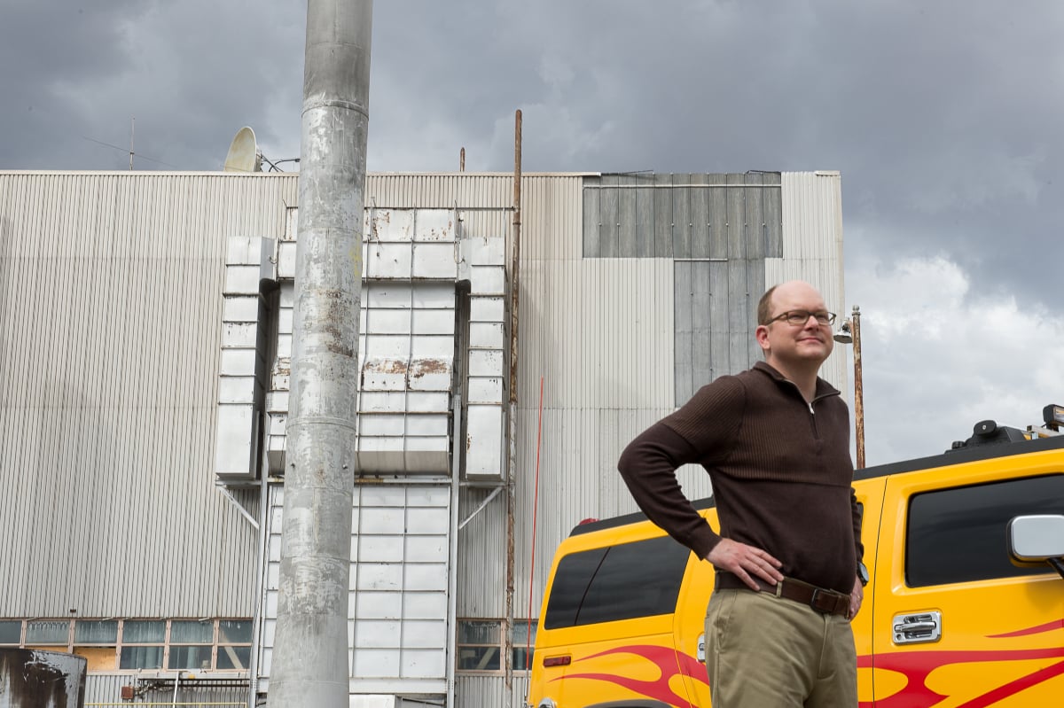 Mark Proksch as Pryce in Better Call Saul Season 2 Episode 1. Pryce stands outside his yellow car with his hands on his hips.