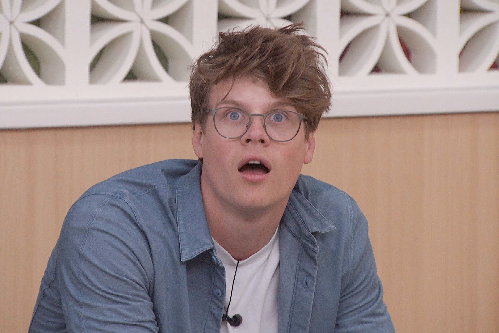 Kyle Capener, who stars in 'Big Brother 24' on CBS, wears a blue long-sleeved button-up shirt over a white shirt and glasses.