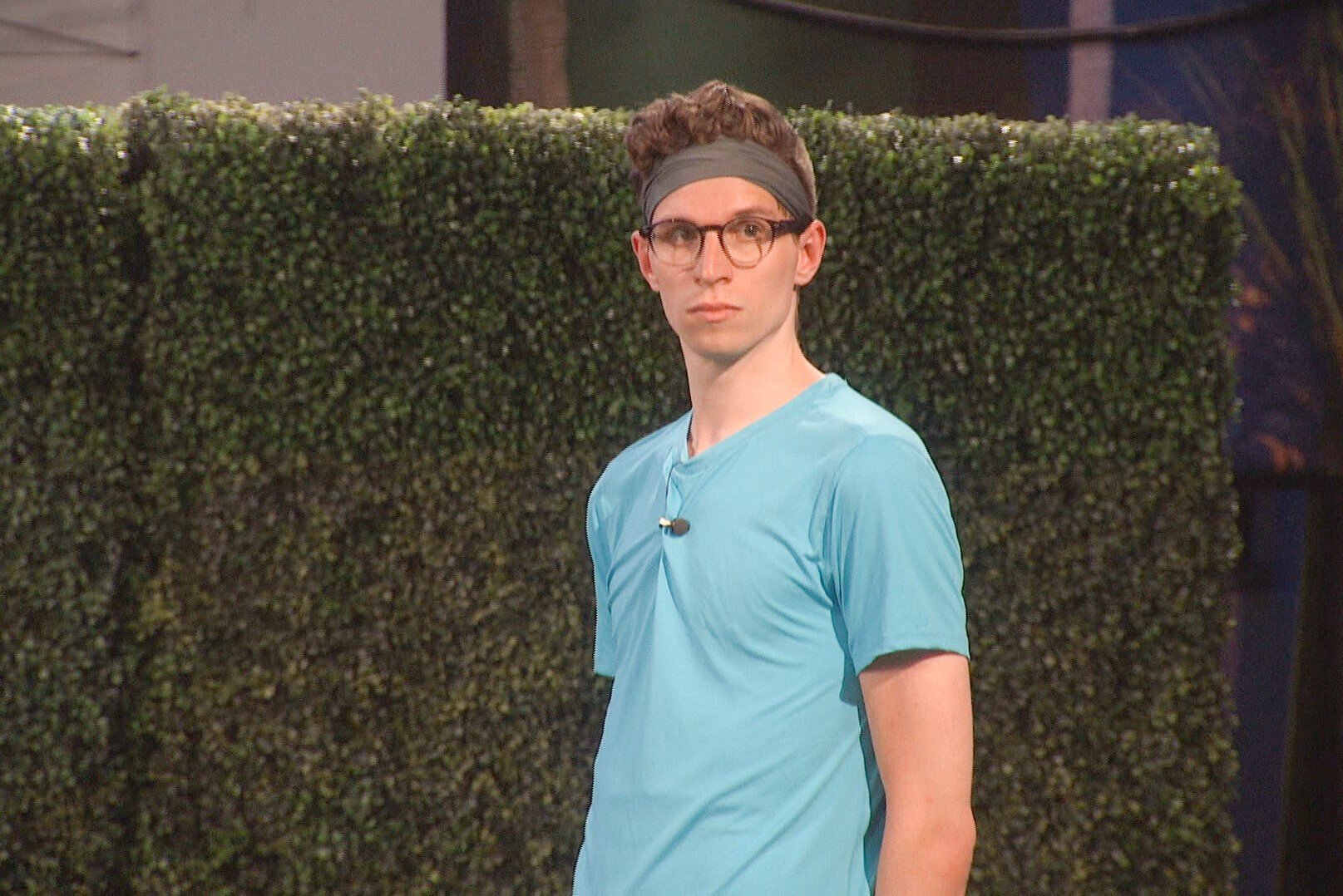 Michael Bruner, who, according to 'Big Brother 24' spoilers, won the Power of Veto in week five, wears a light blue shirt, gray headband, and glasses.