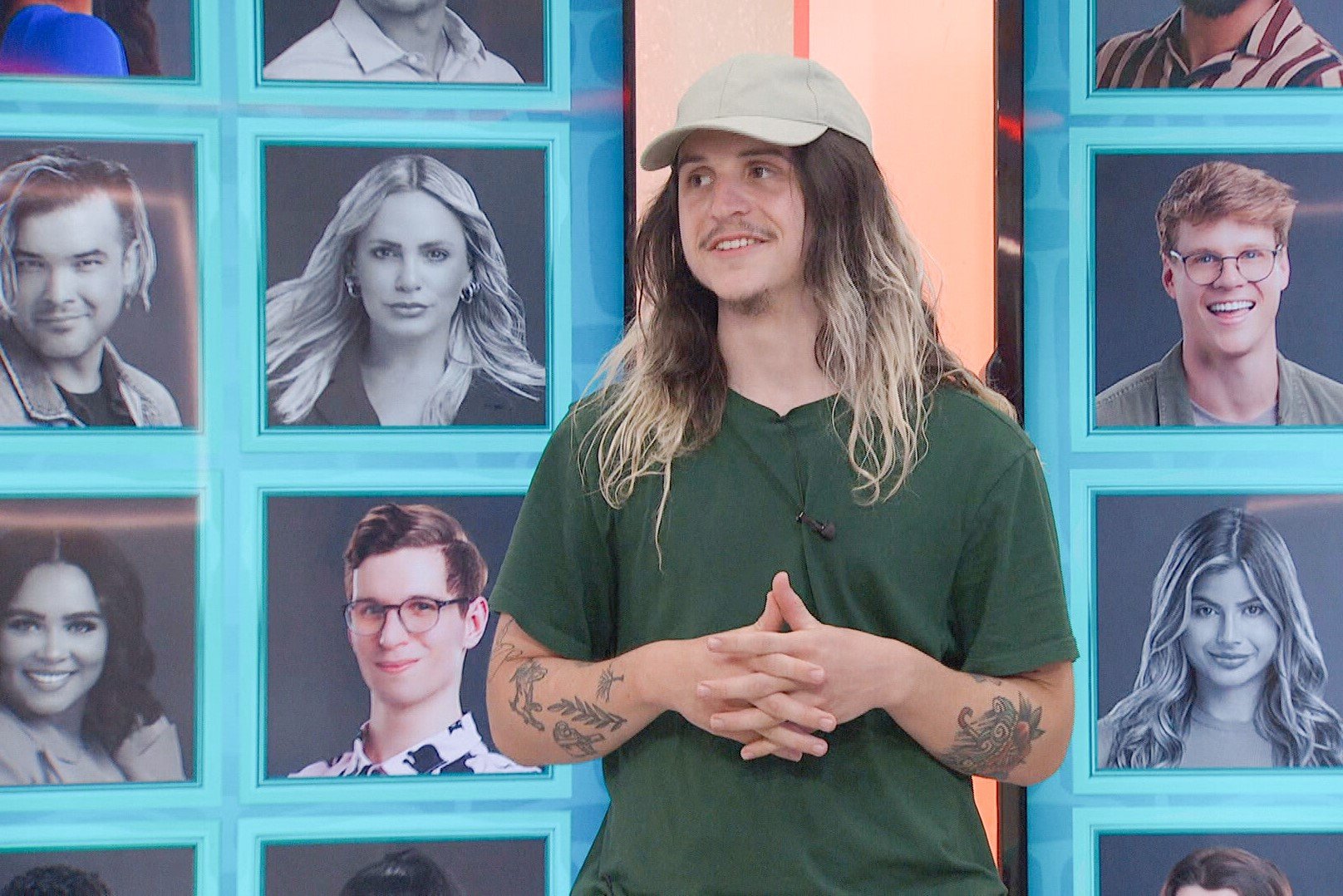 Matthew Turner, who, according to 'Big Brother 24' spoilers, will nominate Kyle Capener for eviction, wears a green shirt and tan baseball cap.
