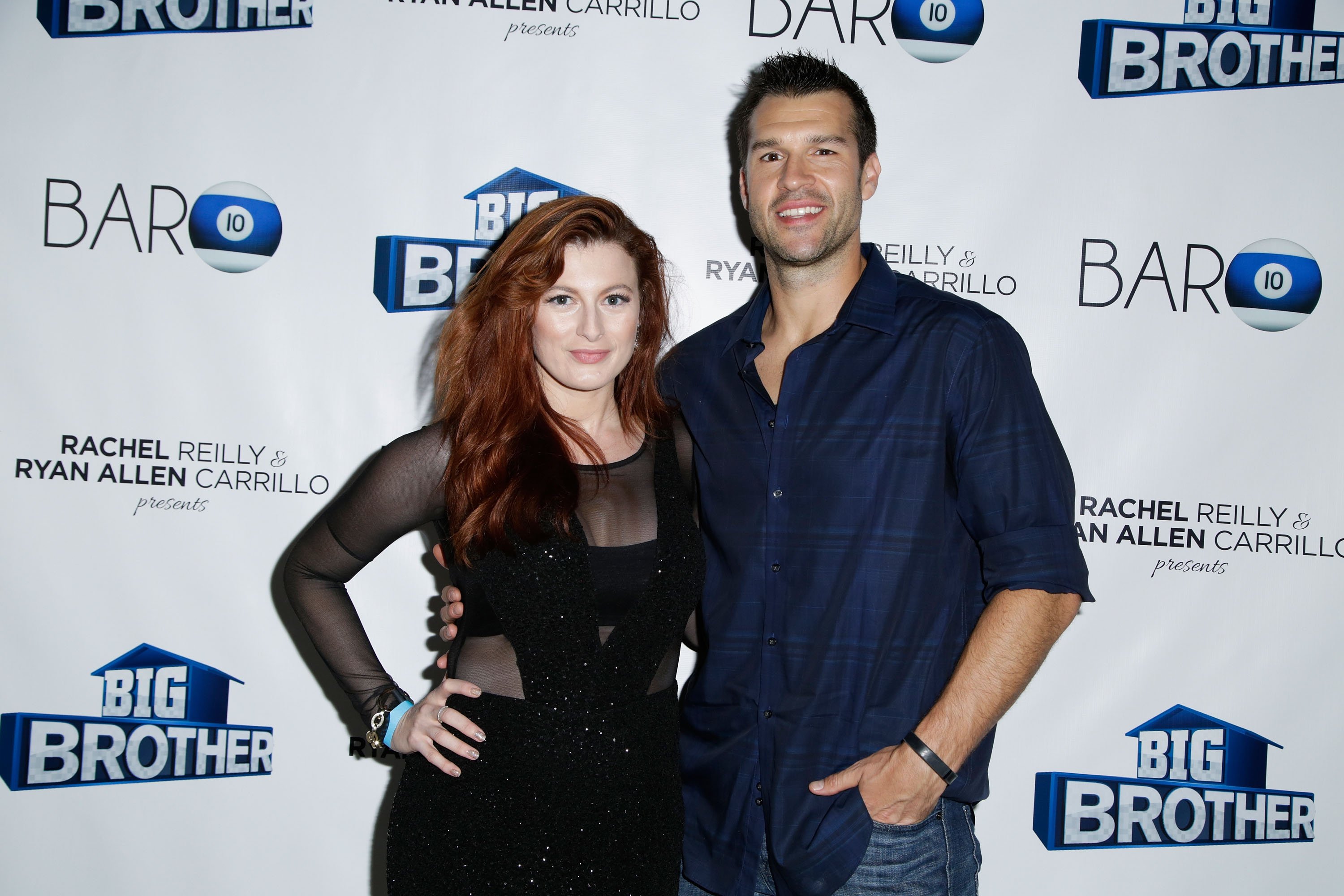 Rachel Reilly and Brendon Villegas, who were one of the famous 'Big Brother' showmances, pose for pictures together. Rachel wears a black dress. Brendon wears a dark blue button-up shirt and jeans.