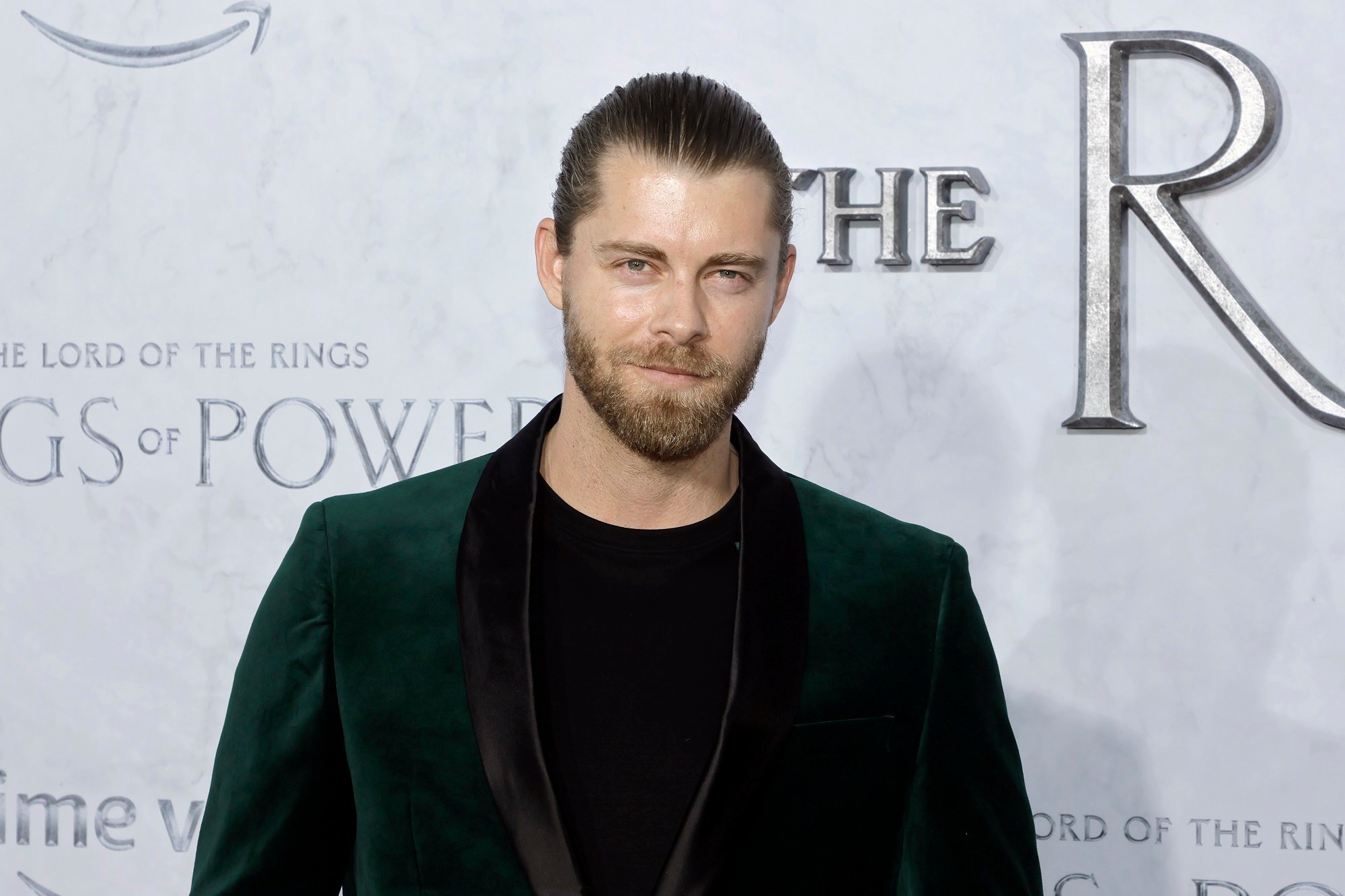 Luke Mitchell smiles at the camera at the premiere of 'The Lord Of The Rings: The Rings Of Power'