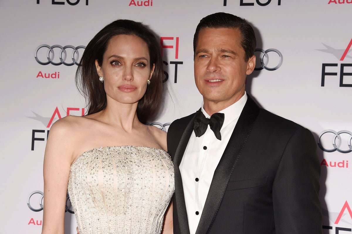 Brad Pitt posing alongside Angelina Jolie.