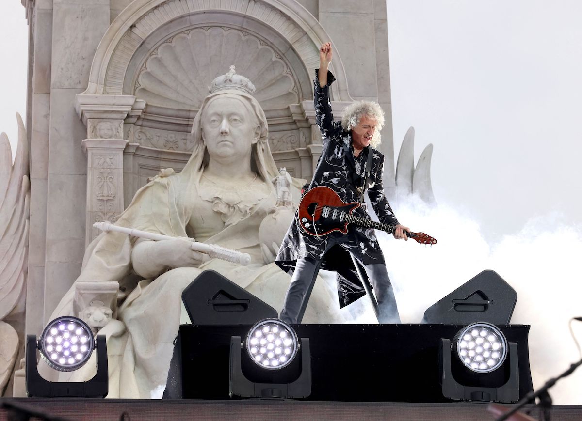 Brian May performing on stage outside Buckingham Palace