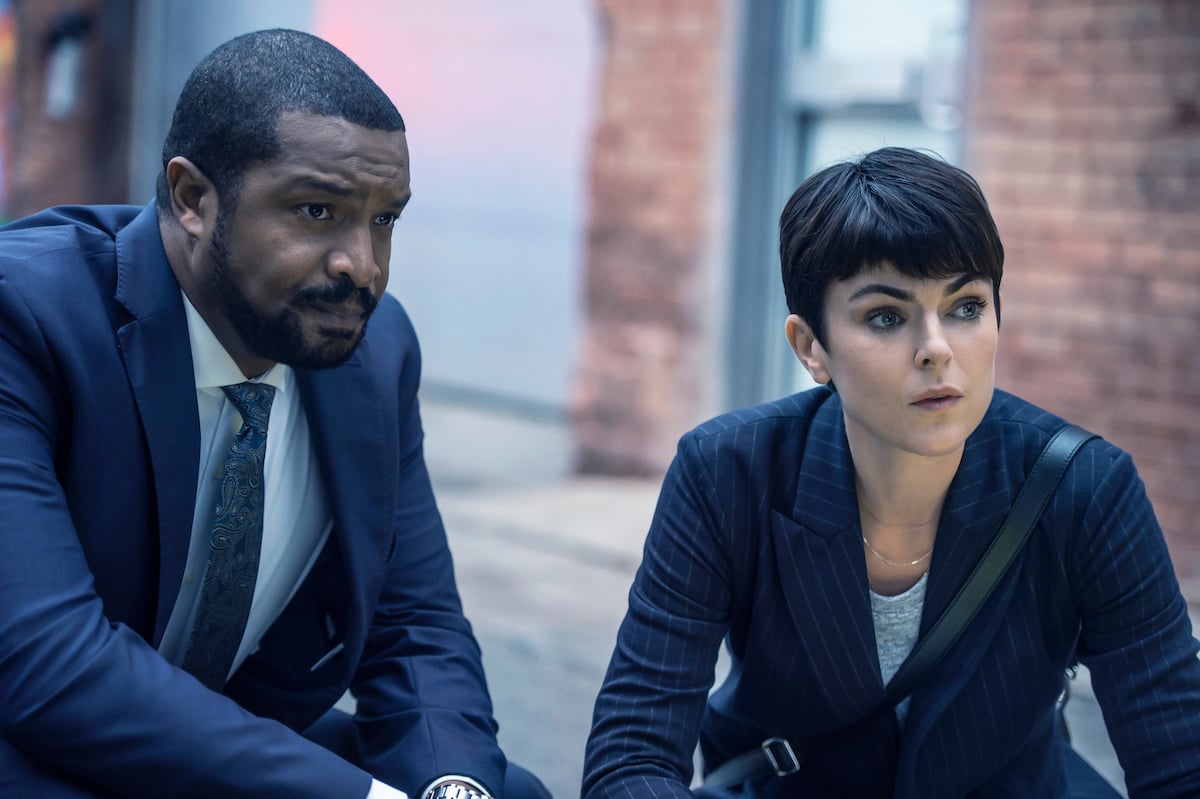 Jenny Cooper (Serinda Swan) and Mac (Roger Cross) exchange theories on the Coroner