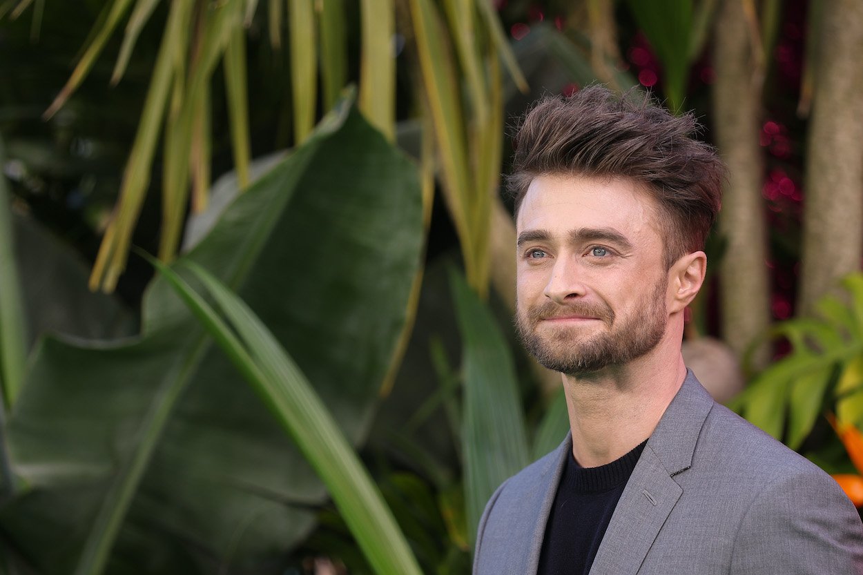Daniel Radcliffe at the U.K. premiere of 'The Lost City' in 2022, posing in front of greenery. Radcliffe has been tied to the Wolverine role in the past, but he sees himself more as a Spider-Man in the Marvel Cinematic Universe.