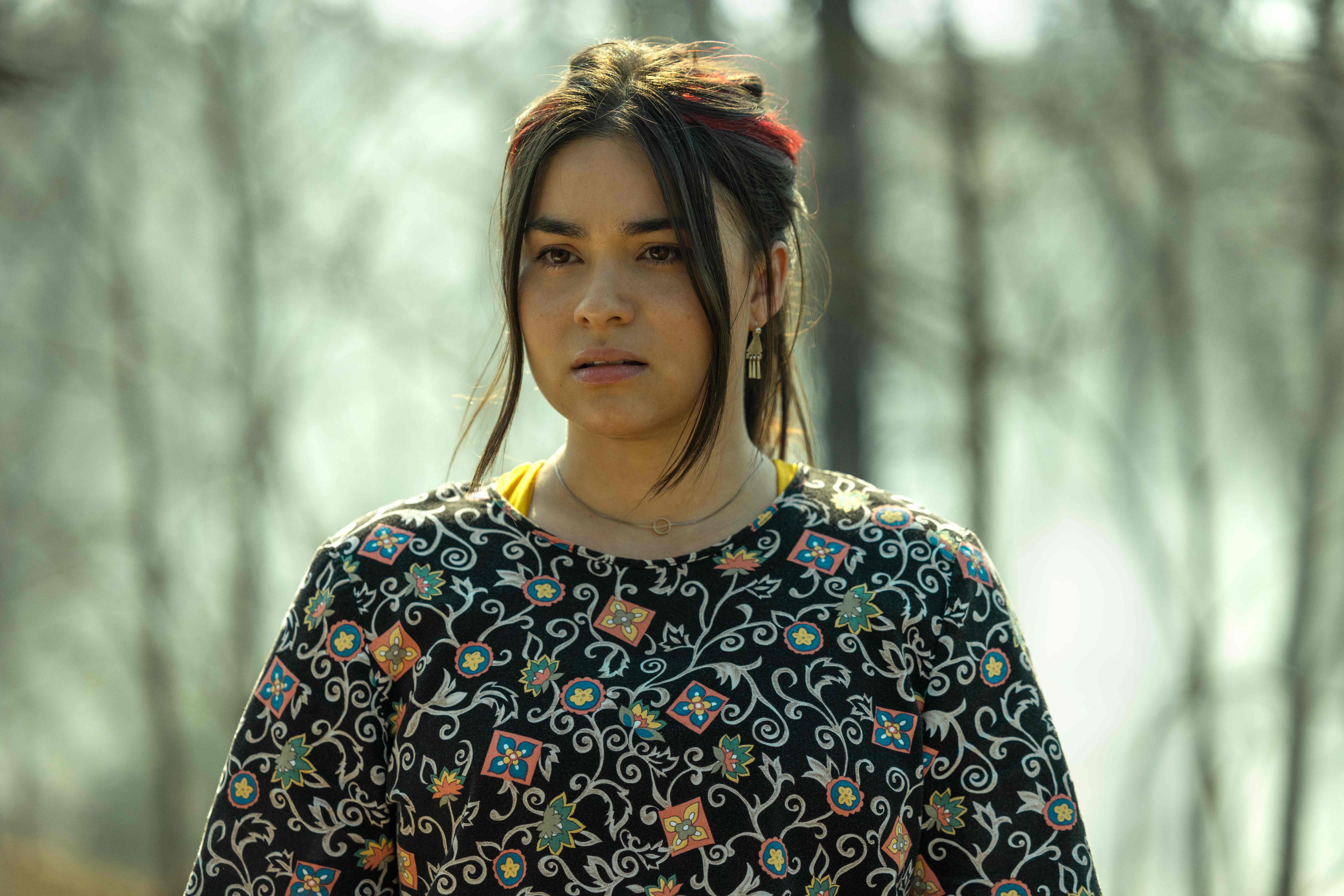 Devery Jacobs as Elora Dana weaing a floral print shirt in 'Reservation Dogs' Season 2