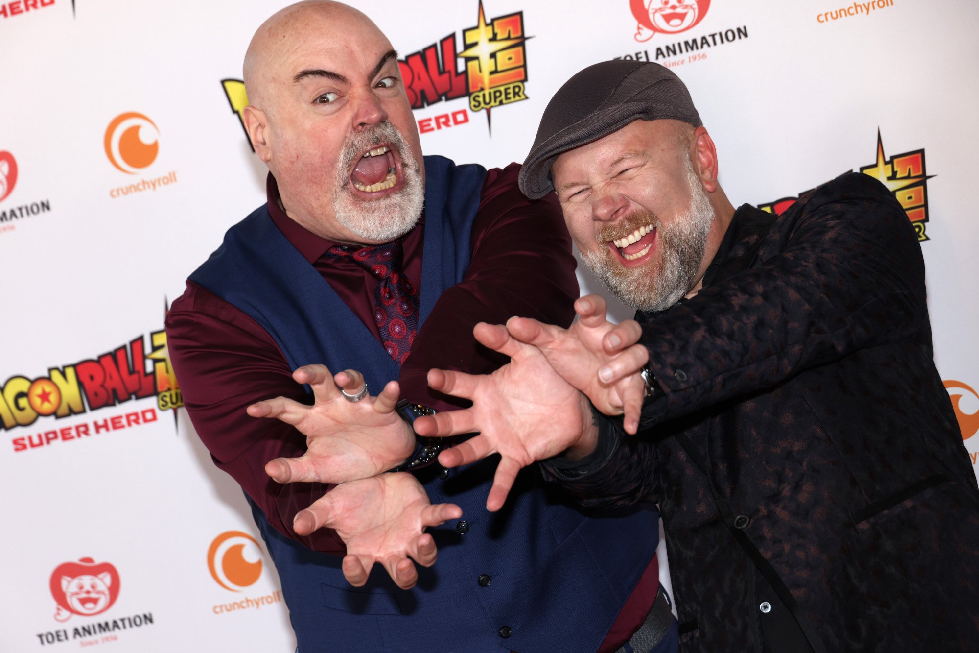 'Dragon Ball Super: Super Hero' cast members Kyle Hebert and Christopher Sabat at the movie's premiere. They're laughing and holding out their hands.