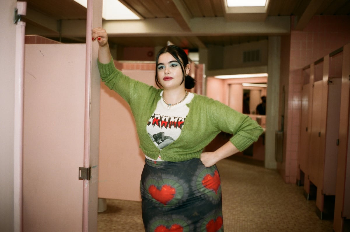 Barbie Ferreira will not return as Kat to Euphoria Season 3. Kat wears a skirt with hears, graphic T, and green cardigan.