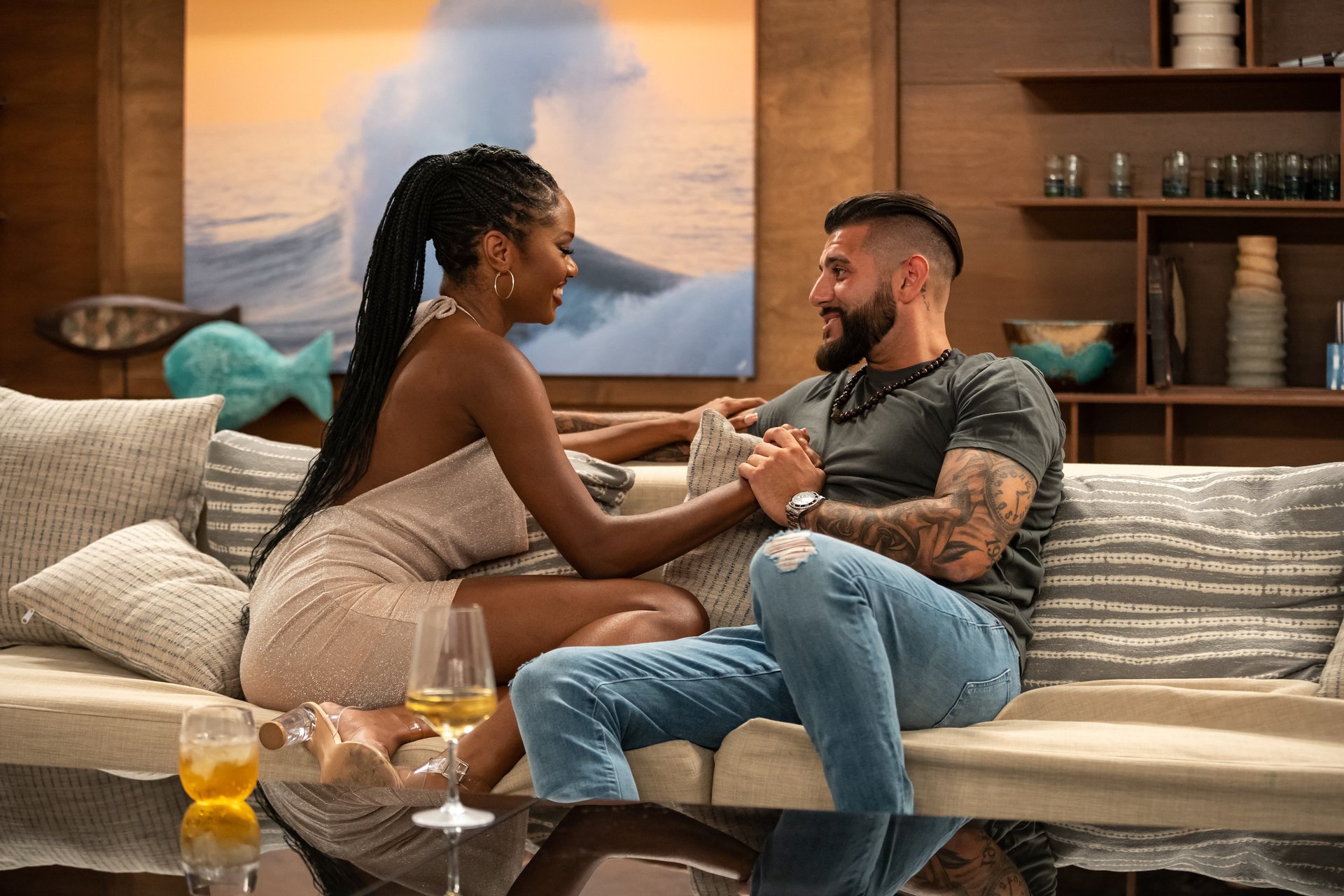 'FBoy Island' Season 2 Mia Emani Jones and Danny Louisa sitting together on a couch holding hands