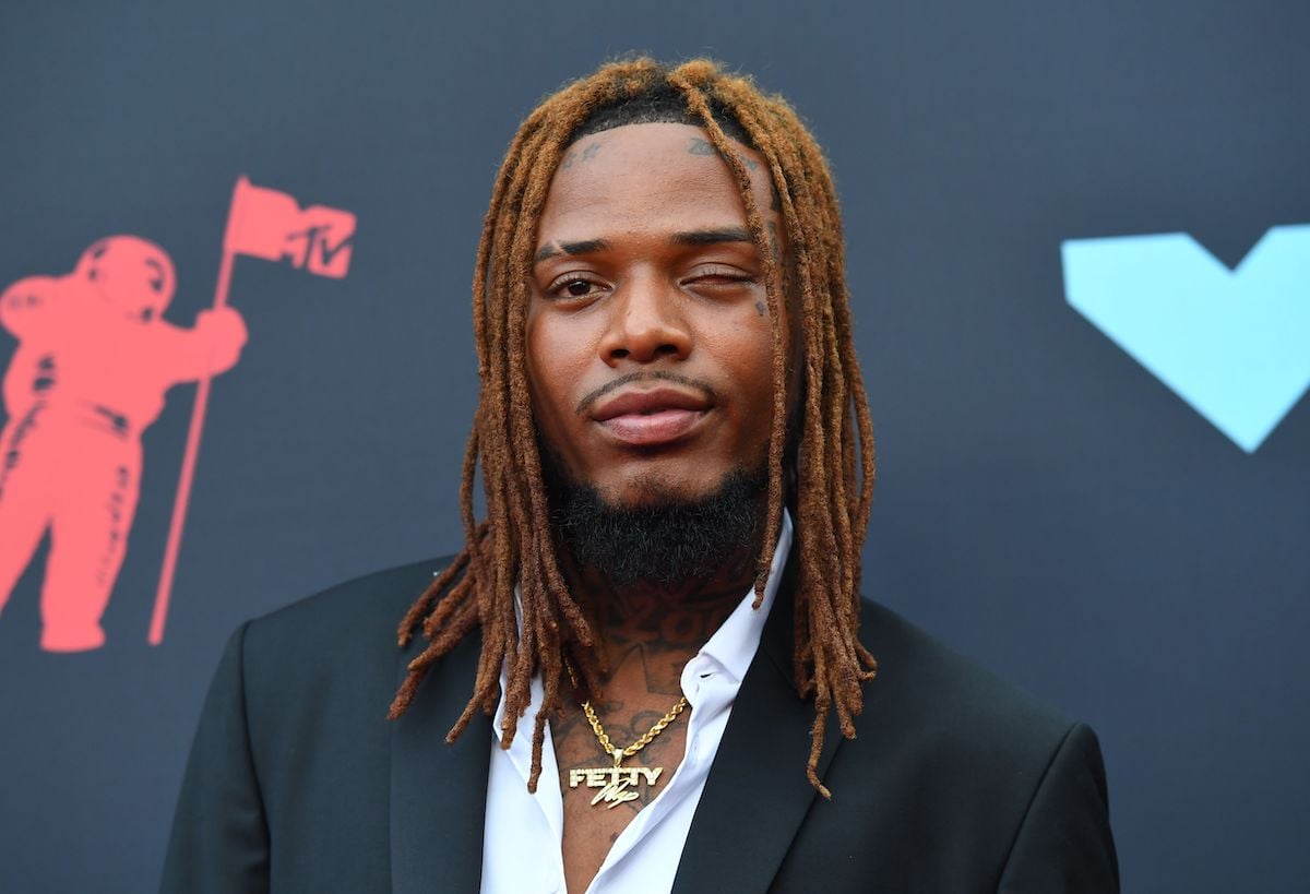 Fetty Wap, who has a net worth of $1 million, poses at an event.