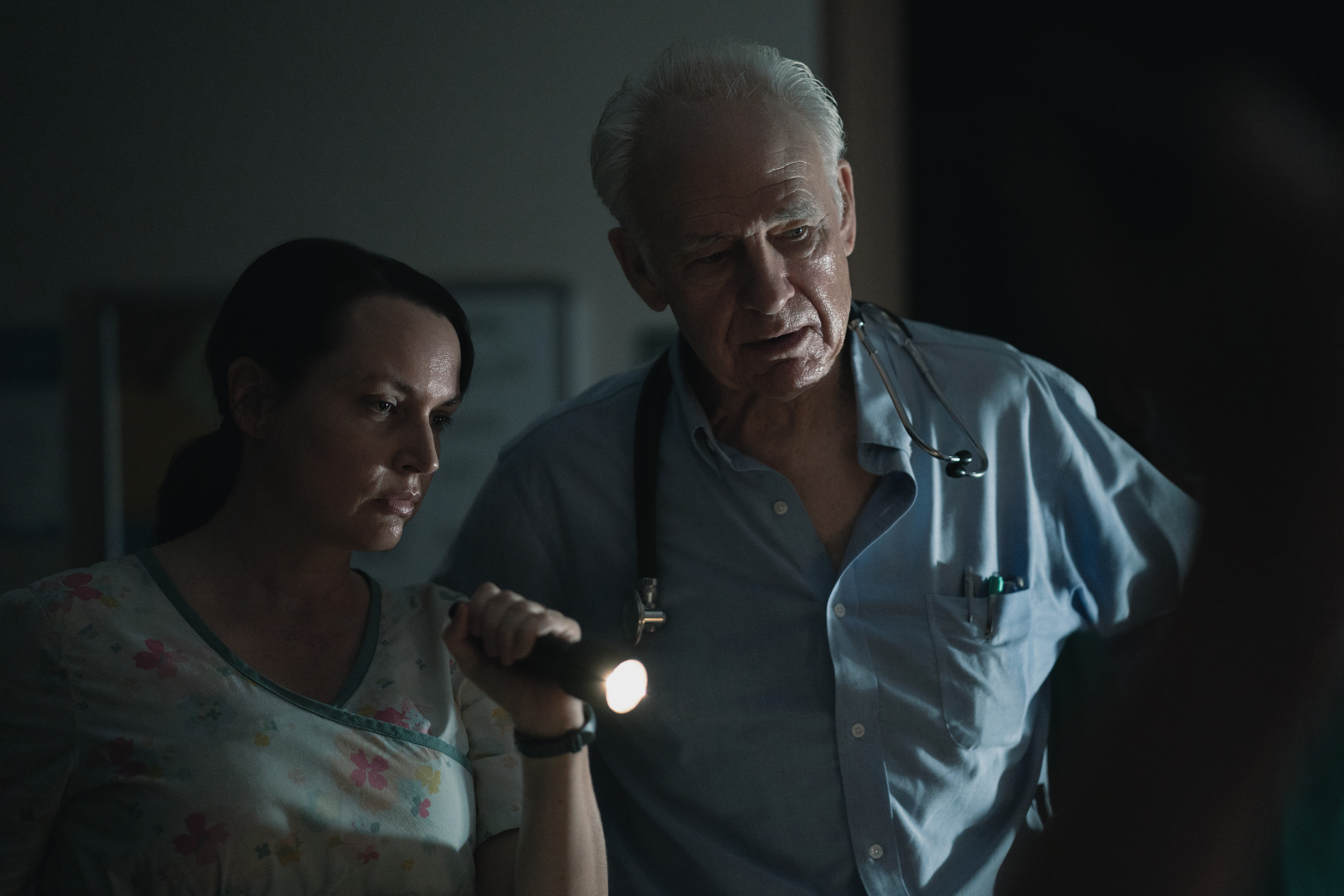 'Five Days At Memorial': Julie Ann Emery and Robert Pine looking at something together with a flashlight