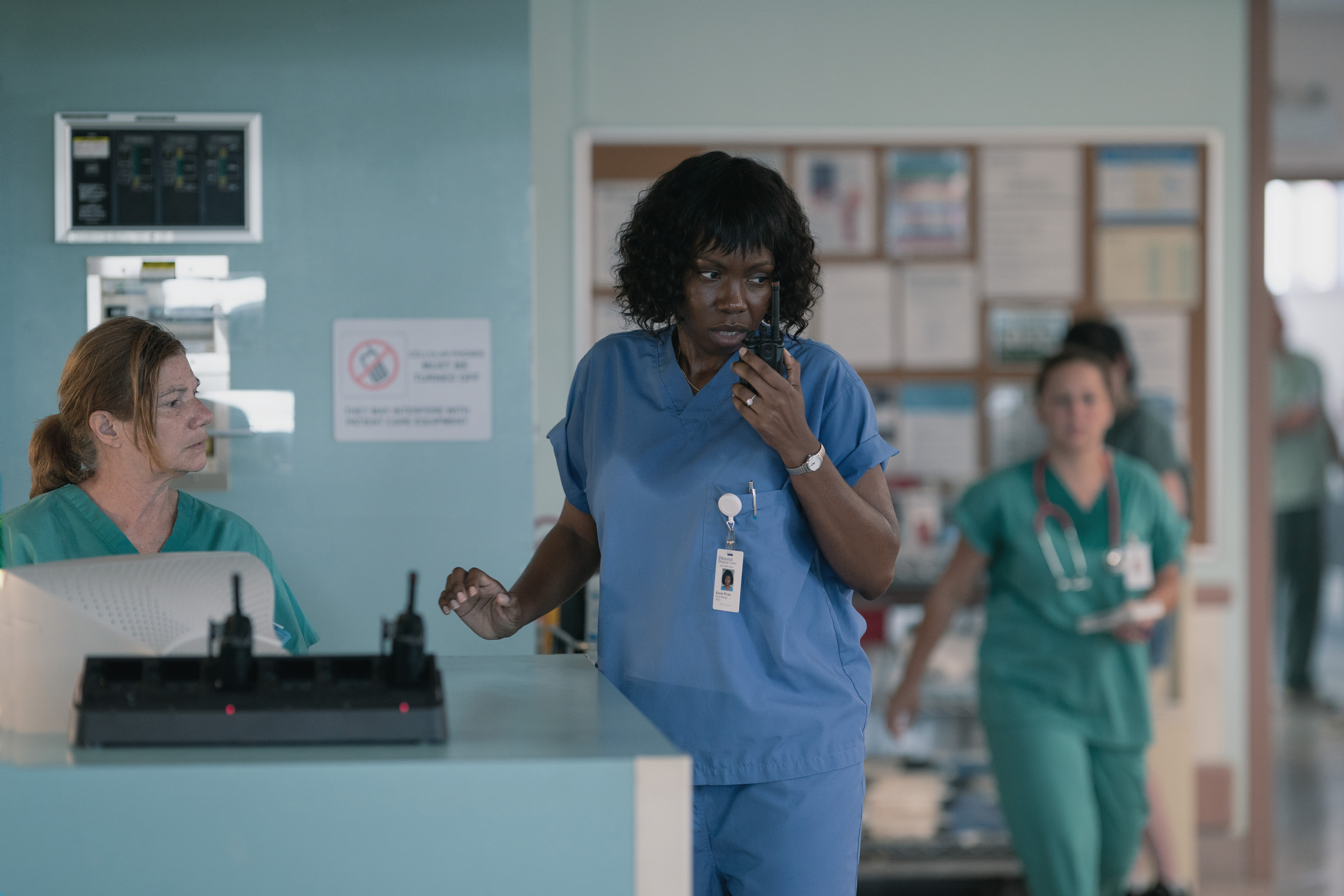 Adepero Oduye playing Nurse Manager Karen Wynn on a walkie talkie