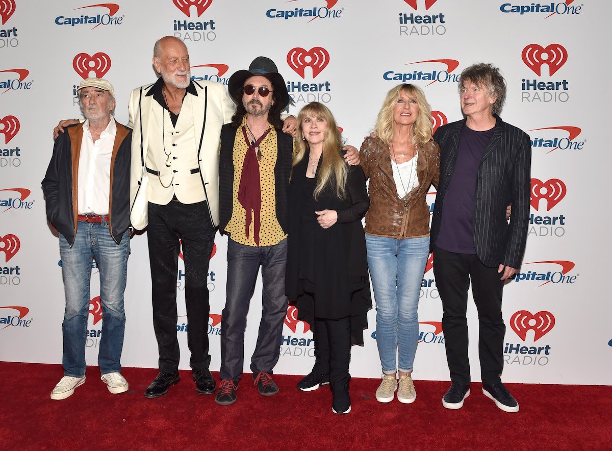 Fleetwood Mac band members pose together at an event.