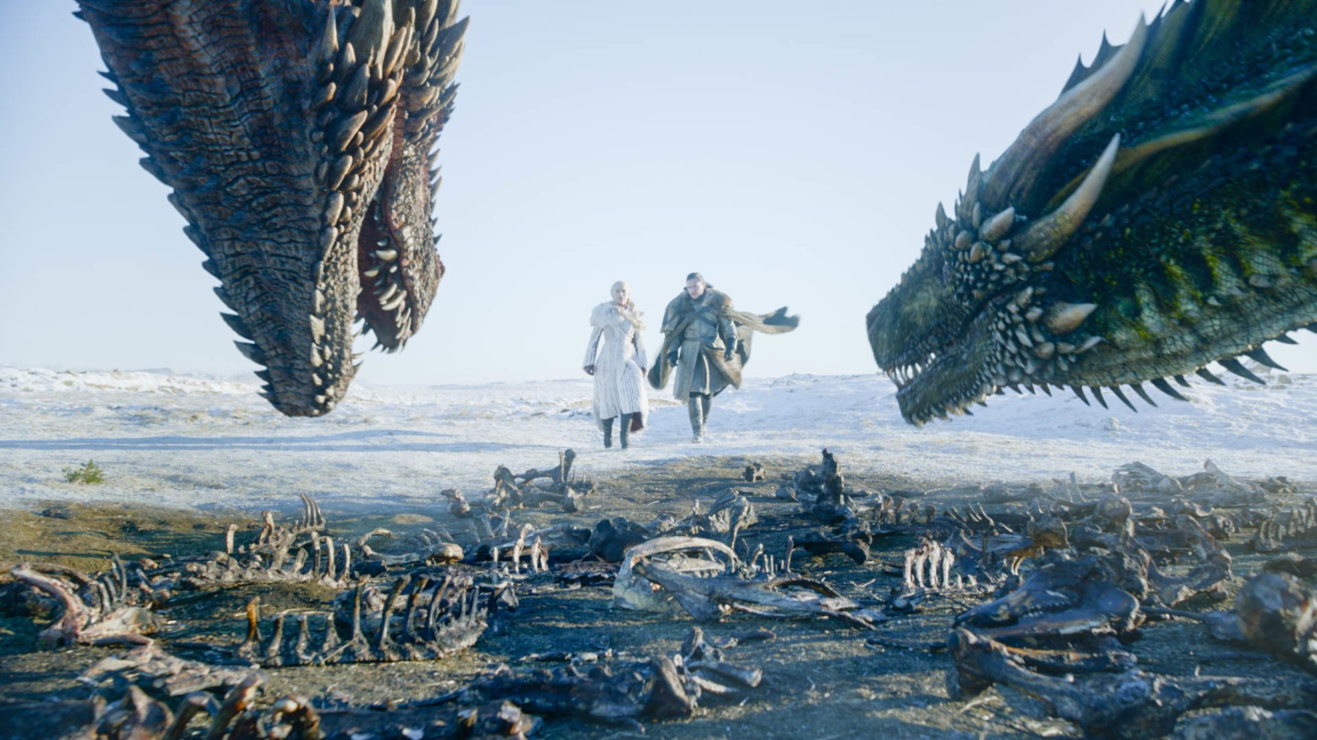 Emilia Clarke and Kit Harington as Daenerys Targaryen and Jon Snow in 'Game of Thrones' Season 8, which will be followed by a Jon Snow spinoff. They're walking next to one another, and they're in between two dragons.