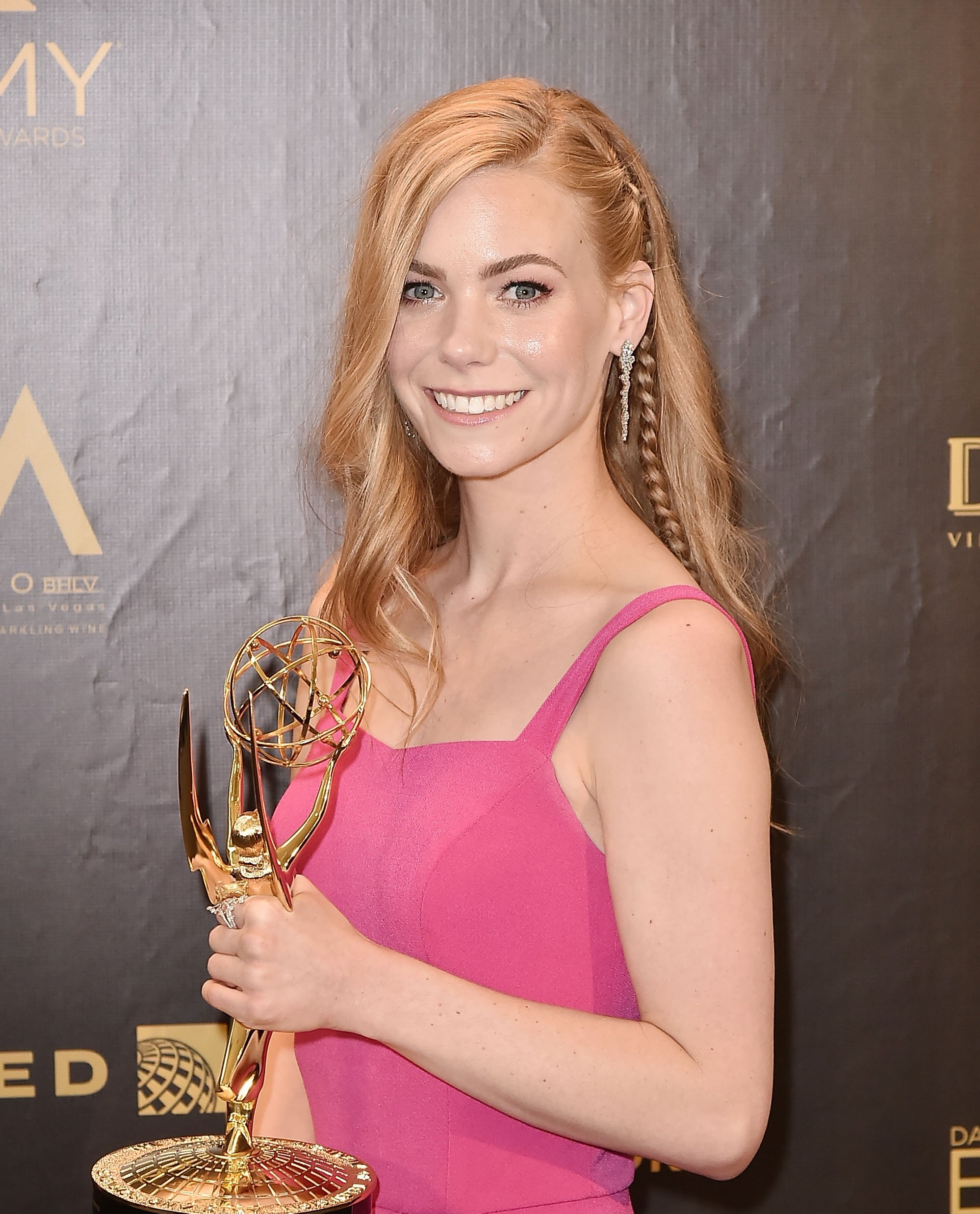 'General Hospital' star Chloe Lanier wearing a pink dress and holding her Daytime Emmy award.