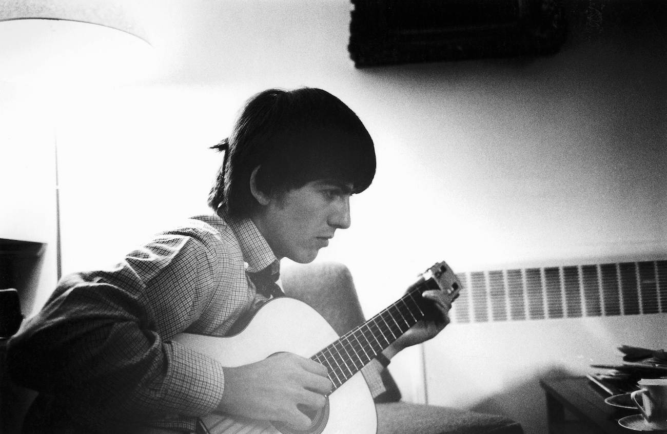 George Harrison playing guitar on the set of 'A Hard Day's Night' in 1964.