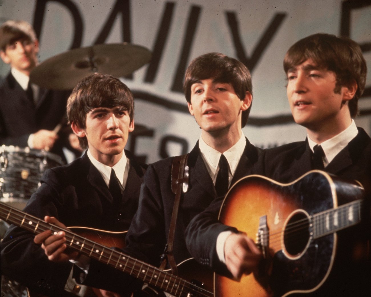 George Harrison, Paul McCartney, and John Lennon performing on TV special in 1963.