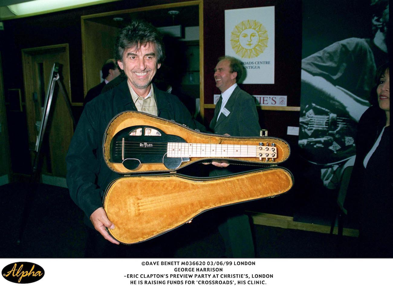 George Harrison with a ukulele at Christie's.