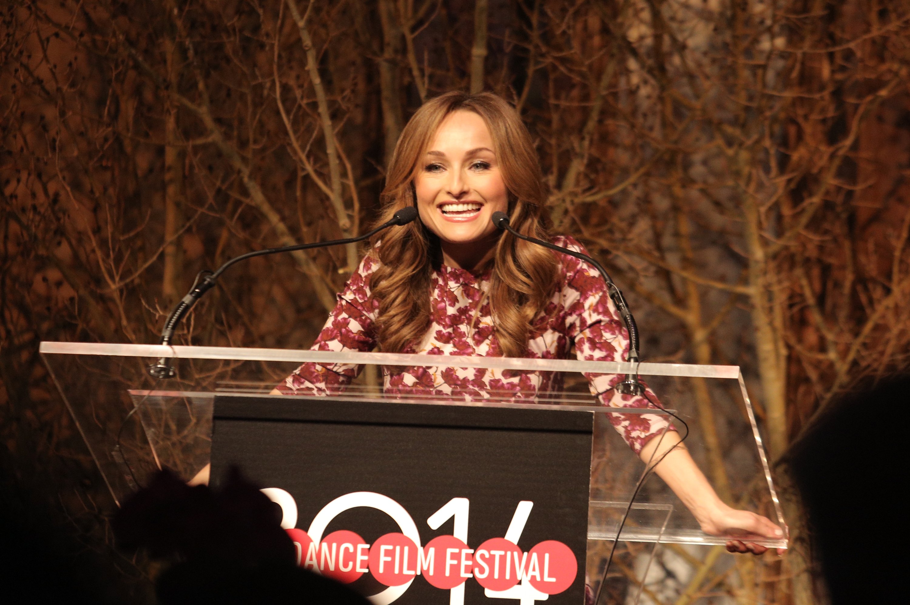 Food Network personality Giada De Laurentiis speaks at a lectern in this photograph.