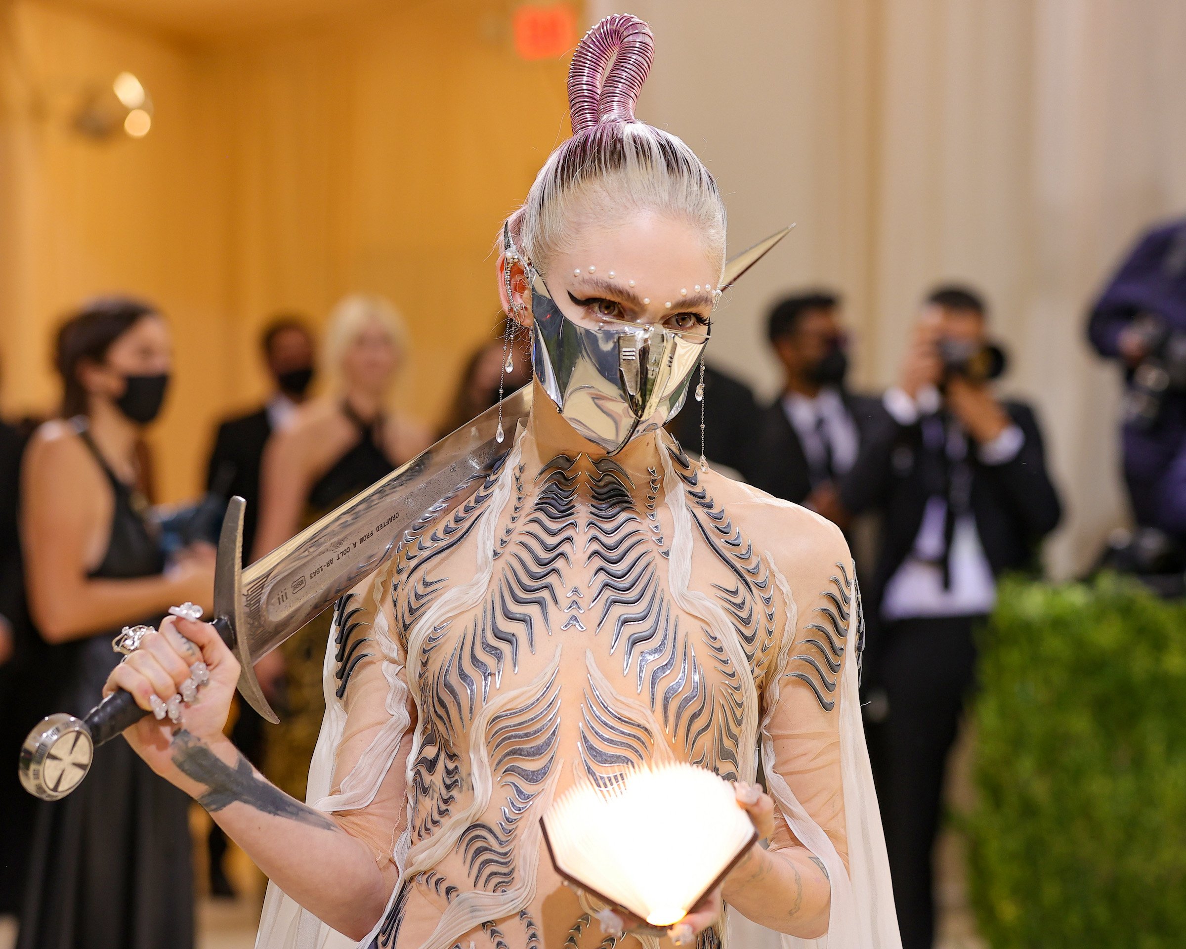 Grimes, who is having surgery on her ears, wearing a silver look at the Met Gala