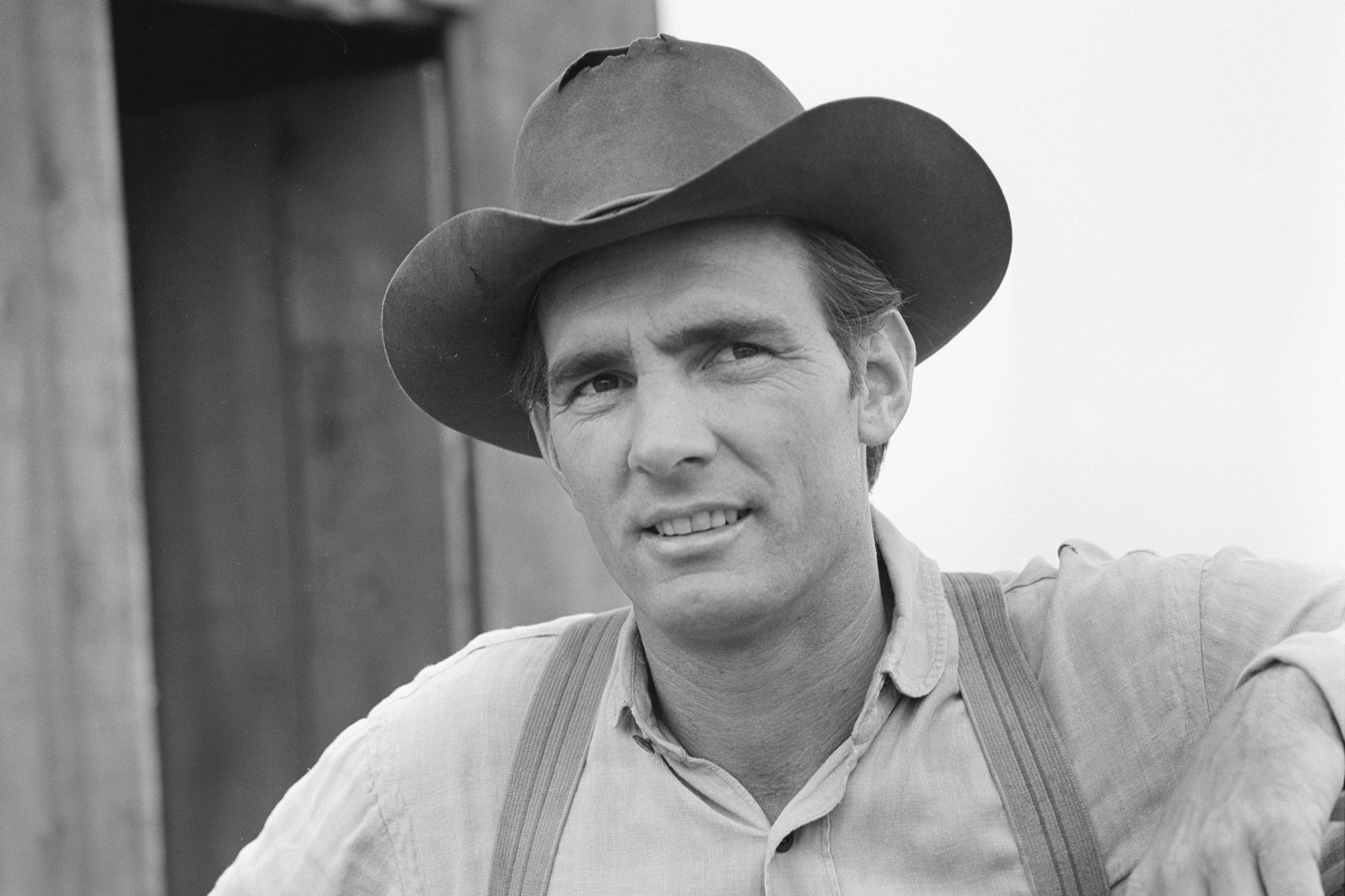 'Gunsmoke' Dennis Weaver as Chester Goode wearing a cowboy hat and overalls smiling.