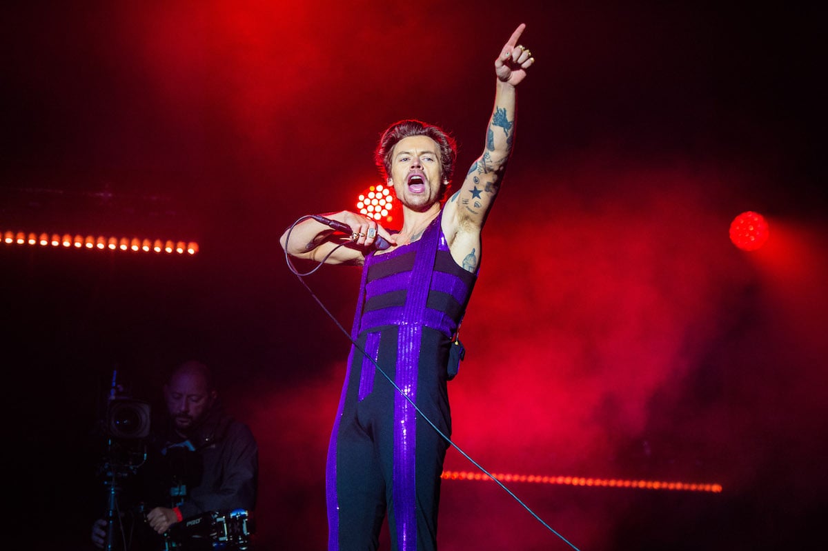 Harry Styles performs in a purple jumpsuit on the Main Stage at War Memorial Park in Coventry, England