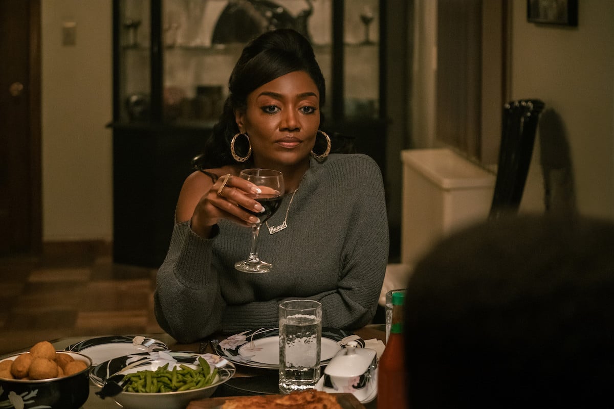 Patina Miller as Raquel Raq Thomas wearing a grey sweater and holding a glass of wine in 'Power Book III: Raising Kanan