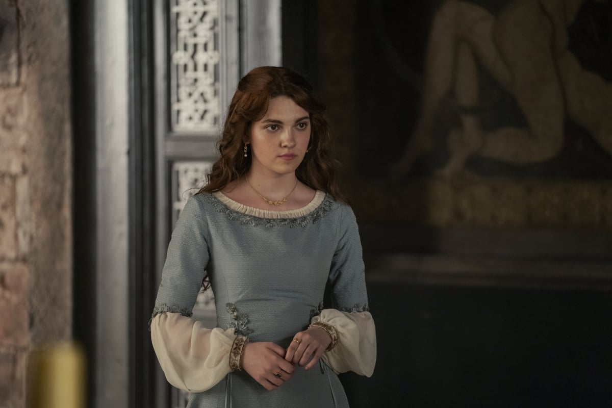 Emily Carey as Alicent Hightower in House of the Dragon. Alicent wears a white and light blue dress. 