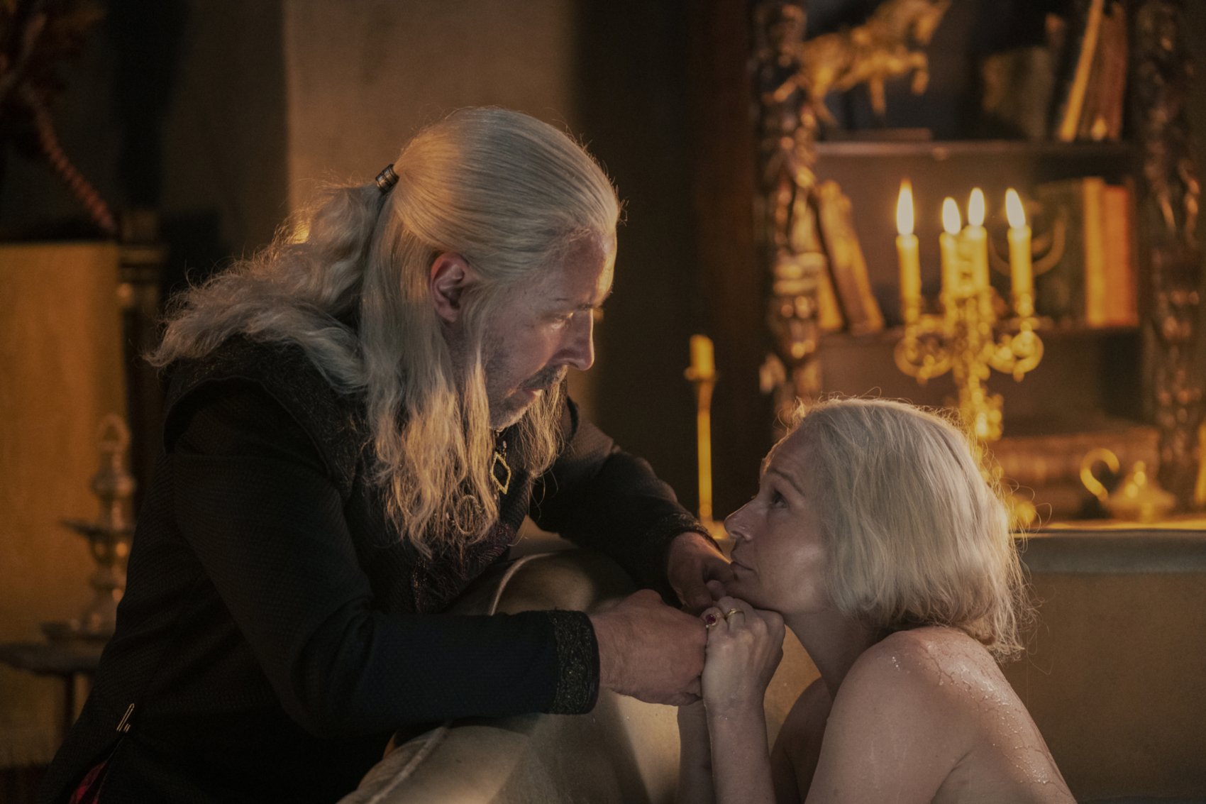 Paddy Considine and Sian Brooke as Viserys Targaryen and Aemma Arryn in 'House of the Dragon,' which showrunner Miguel Sapochnik says approaches violence 'thoughtfully.' Aemma is in the tub, and Viserys is leaning over it from outside. They're both staring at one another.