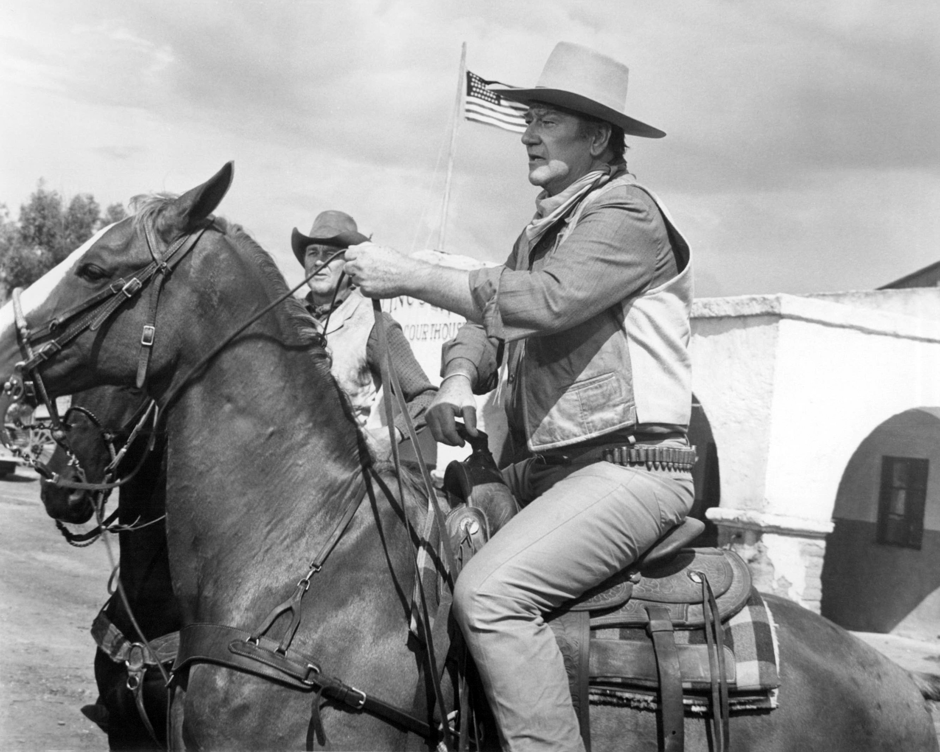 John Wayne riding a horse